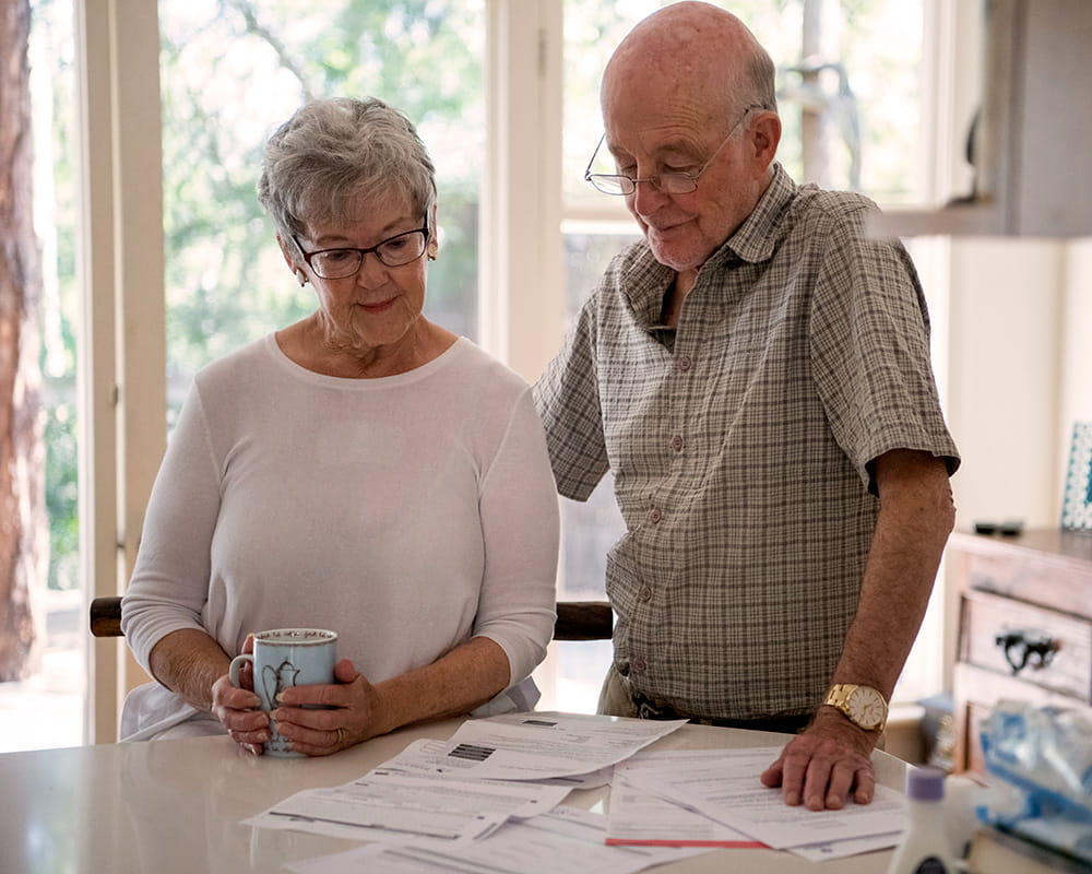 a picture of one person helping another person go through applications